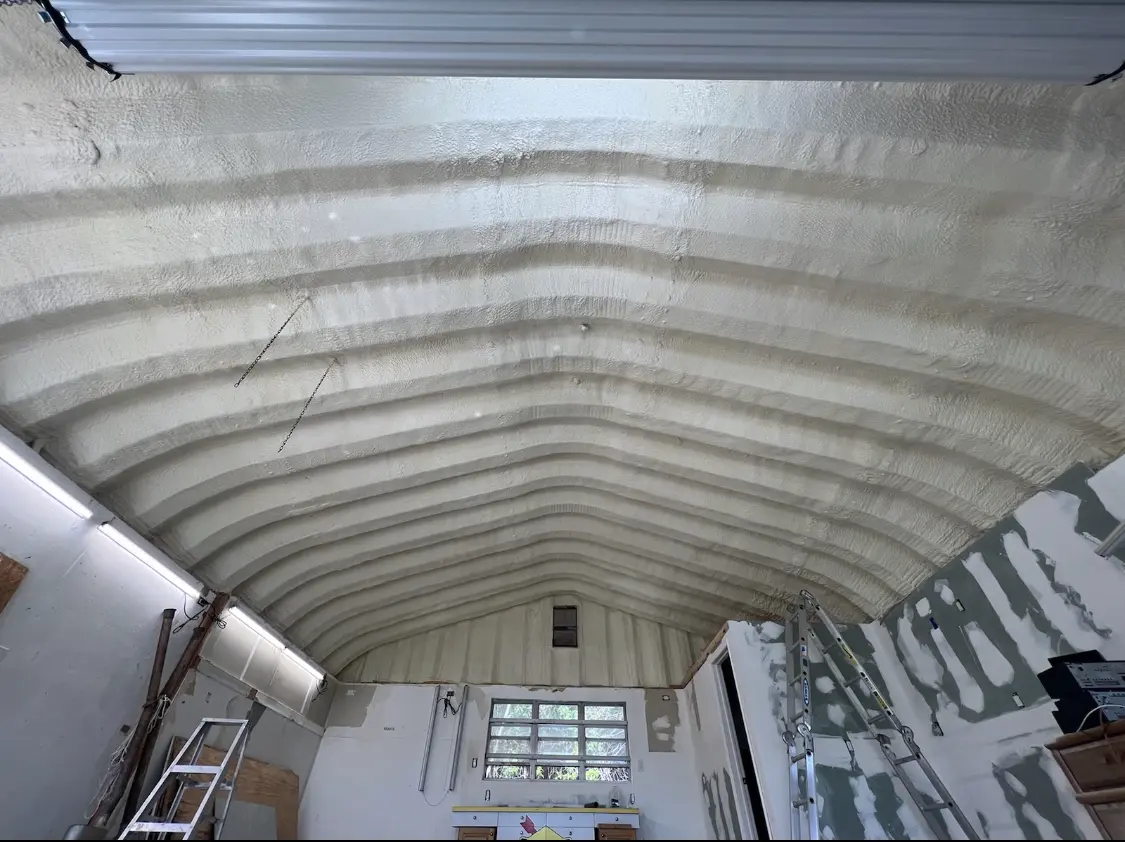 Spray polyurethane foam applied to the underside of a metal roof deck in Hampden